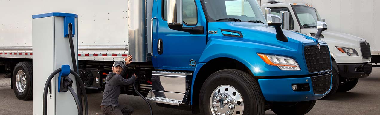 man charging an international eMV electric truck