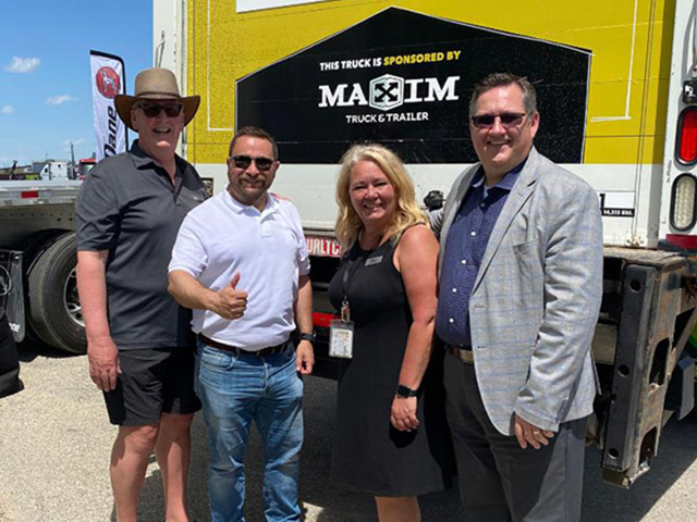 people standing in front of a truck.